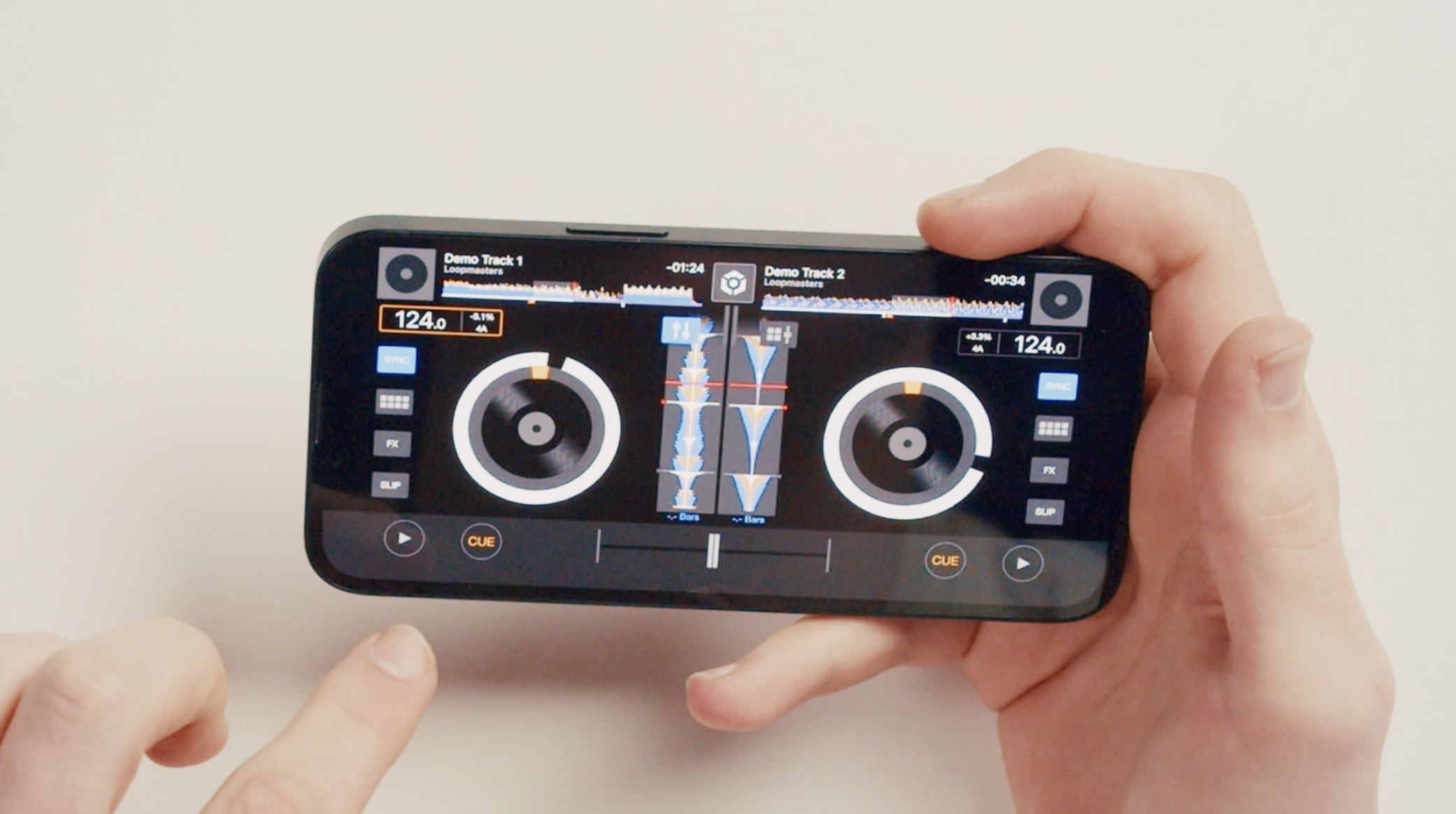 Close up of hands holding an iPhone with rekordbox iOS.
